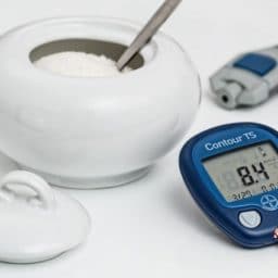 bowl of sugar and blood glucose reader