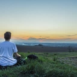 Person meditating on a hill