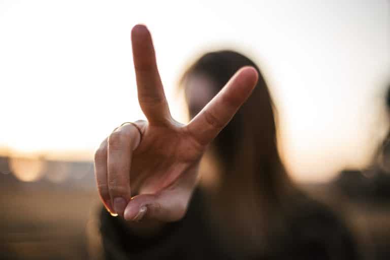 Woman holding up two fingers.