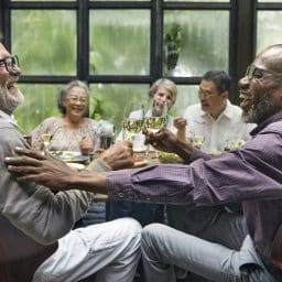 Group of older friends enjoying a meal together.