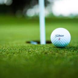 Close-up of a golf ball on a golf course.
