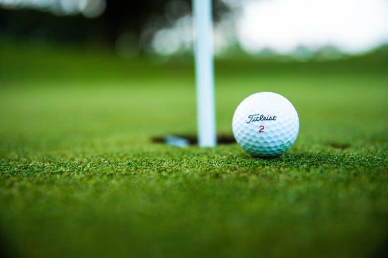 Close-up of a golf ball on a golf course.